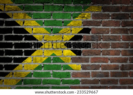Very old dark red brick wall texture with flag - Jamaica