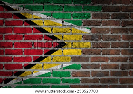 Very old dark red brick wall texture with flag - Guyana