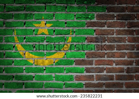 Very old dark red brick wall texture with flag - Mauritania