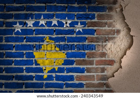 Dark brick wall texture with plaster - flag painted on wall - Kosovo
