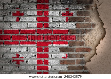 Dark brick wall texture with plaster - flag painted on wall - Georgia