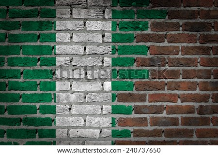 Very old dark red brick wall texture with flag - Nigeria