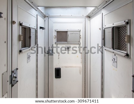Inside of a large bus used by police to transport prisoners for public safety