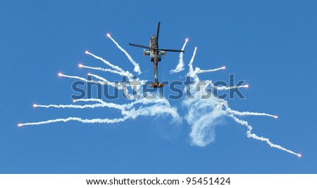 LEEUWARDEN,FRIESLAND,HOLLAND-SEPTEMBER 17:: Apache AH-64D Solo Display Team shoots flares at the Airshow on September 17, 2011 at Leeuwarden Airfield, Friesland, Holland.