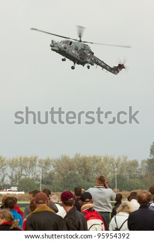 LEEUWARDEN,FRIESLAND,HOLLAND-SEPTEMBER 17: Royal Navy Helicopter Display Team \'Black Cats\' at the Luchtmachtdagen Airshow on September 17, 2011 at Leeuwarden Airfield, Friesland, Holland.