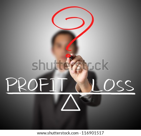business man writing profit and loss compare on balance bar