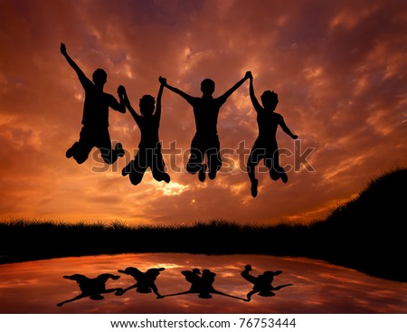 silhouette of friends jumping with joy at sunset