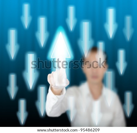 business man pointing rising arrow against others falling on modern digital screen