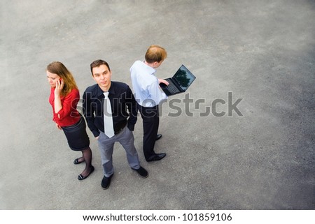 Image of a business team using communication and standing on the street. They have many ideas.