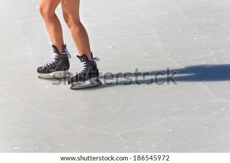 Image of people who are ice skating in the ice rink at the Medeo