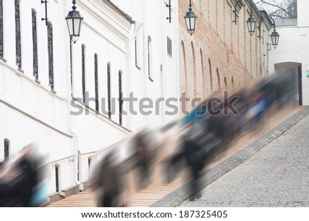 crowd in motion blur on a city street in the park