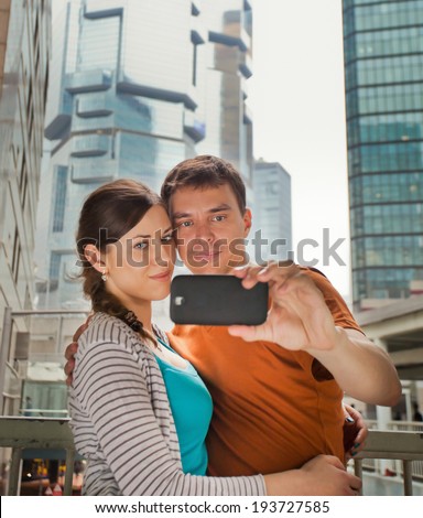 couple in love to photograph together during a trip to Hong Kong, hugging and smiling