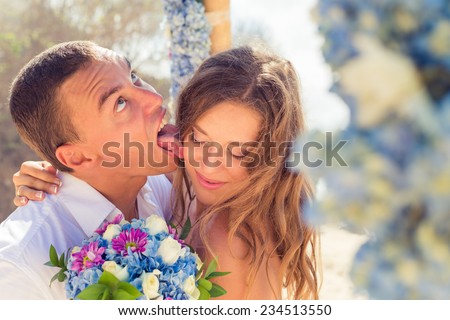 Groom licks bride at a wedding ceremony, Bali