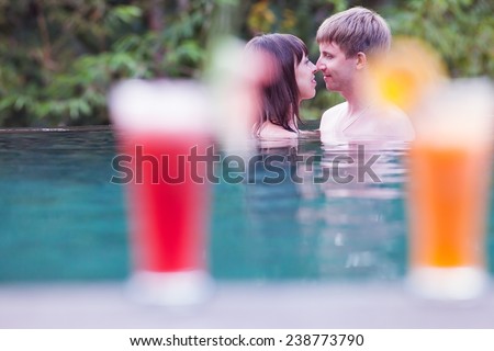 first date lovers at water in pool, through cocktail background