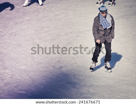 Mature adult who are ice skating at the ice rink outdoors at Medeo