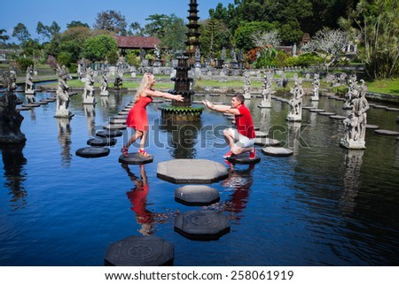man makes a marriage proposal to his girlfriend, Bali, Water Place