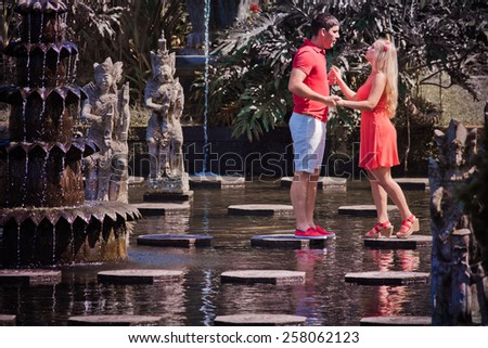 man makes a marriage proposal to his girlfriend, Bali, Water Place