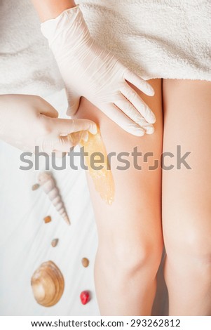 Sugaring epilation skin care with liquid sugar at legs. You can see her smooth and hair free armpits after hair removal.