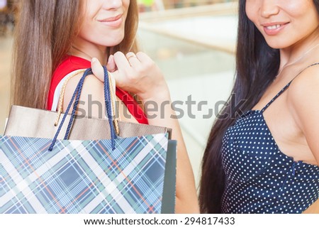 Closeup happy shopping women with a bags at shopping center. There is a copy space for any text or label design
