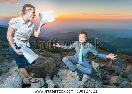 Concept of conflict at work. Woman head shouts at his subordinate, she holding documents or papers. But the man is relaxing and sitting in yoga pose at summit of mountain
