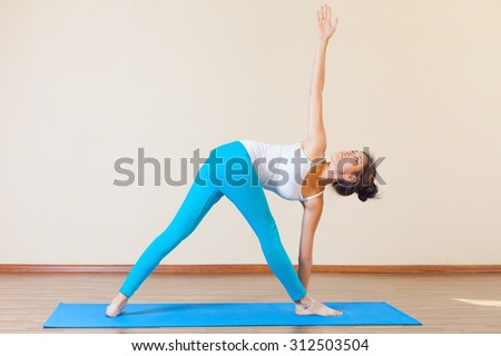 Inspired asian woman doing exercise of yoga indoor at class of yoga. Concept of a healthy lifestyle, sport and the right attitude to life