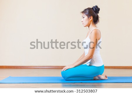 Inspired asian woman meditating before yoga exercise indoor at home. Concept of a healthy lifestyle, sport and the right attitude to life