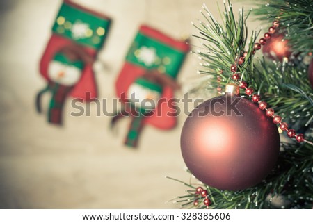 Christmas tree with beautiful decoration ready for xmas holiday. Wooden backdrop with two red socks for gift or present for your family