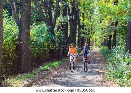 Activity image of young couple travel by bicycle together at sunset light in National Park