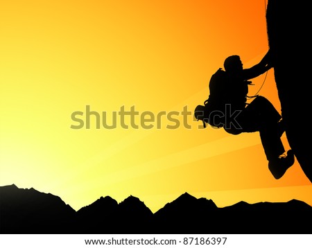 Silhouette of climbing young adult at the top of summit with aerial view on mountain range and sun ray