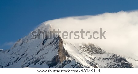 Summit of jungfrau - top of Europe in Grindelwald ski area. Switzerland. There are a blue sky and clouds