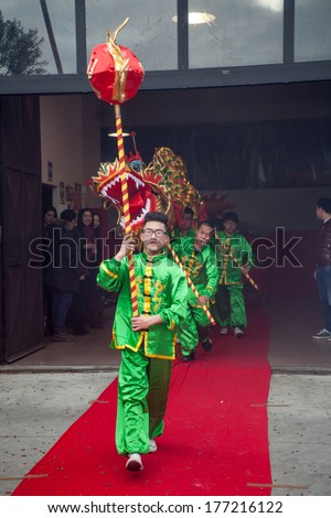 PRATO, ITALY - FEBRUARY 15: The traditional dragon run out from a factory during the celebration of the Chinese New Year, on February 15, 2014 in Prato (Italy)