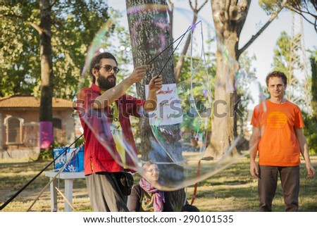 FLORENCE, ITALY - 20 JUNE 2015 - An animator performs with soap bubbles on June 20, 2015 in Florence (Italy)