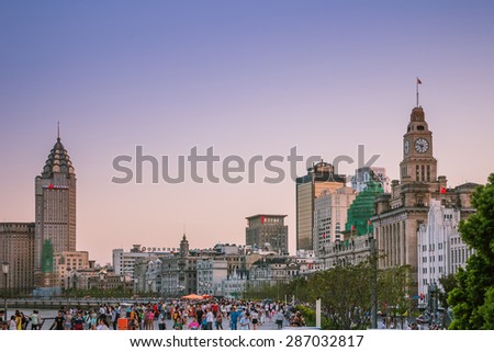 SHANGHAI, CHINA - SEP 16: people walking at the bund waterfront hangpu river on Sep 16, 2013 in Shanghai, The bund is the western bank of the Hangpu river facing pudong district.