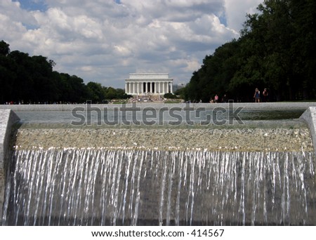 The Lincoln Memorial is seen from a waterfall at the World War II memorial.