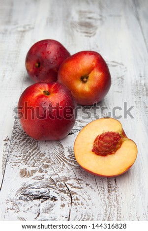 Juicy fresh peaches on a white wooden background