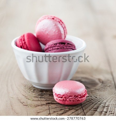 Colorful French macaroons on a rustic wooden background, selective focus