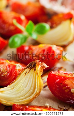 Baked tomatoes with herbs and onion on textured background, selective focus