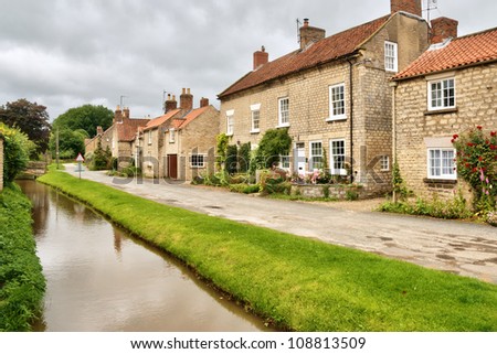 Quaint cottages and stream in an English village