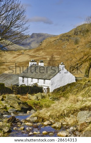 Scenic view of mountainous landscape of Lake District National park with Blea Tarn house in foreground, Cumbria, England
