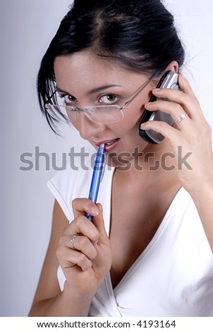 Picture of woman handwriting notes from phone call with blue pen.