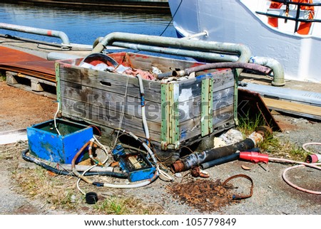 Pile of junk in and around a wooden container