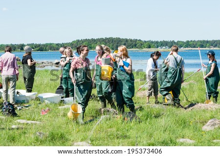 KALMAR, SWEDEN - MAY 26: Female students on ecology, biology field trip to study marine life.