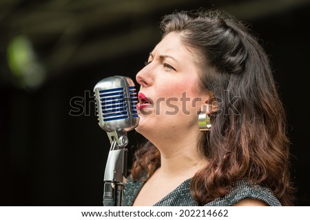 RONNEBY, SWEDEN - JUNE 28, 2014: Nostalgia Festival, classic cars, motorcycles, fashion and entertainment. TherÃ?Â?Ã?Â©se Moller as Cherry Tess singing.