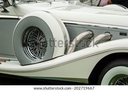 RONNEBY, SWEDEN - JUNE 28, 2014: Nostalgia Festival with classic cars and motorcycles as main attractions. Detail of spare tire with spokes on grey Excalibur classic car.