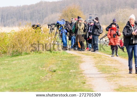 BEJERSHAMN, SWEDEN - APRIL 25, 2015: Birdwatchers looking after migratory birds in wetland as they arrive in early spring. Bejershamn is a protected wildlife reserve known for its birdlife.