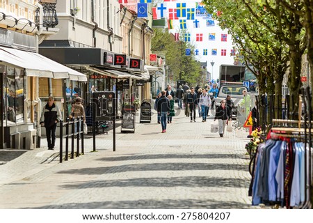 KARLSHAMN, SWEDEN - MAY 06, 2015: Normal day in the city of Karlshamn. People walk around on main street. Shops are open and trucks unload their goods.