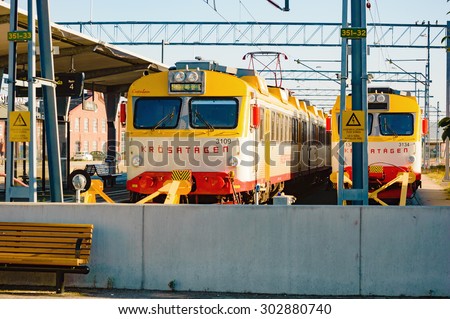 KARLSKRONA, SWEDEN - AUGUST 03, 2015: Delays and poor track qualities are only some of the resent problems in Swedish railway business. Here are two trains at the station one summer morning.