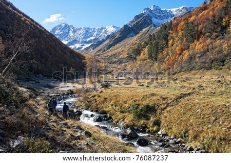 Autumn hiking alongside mountain river