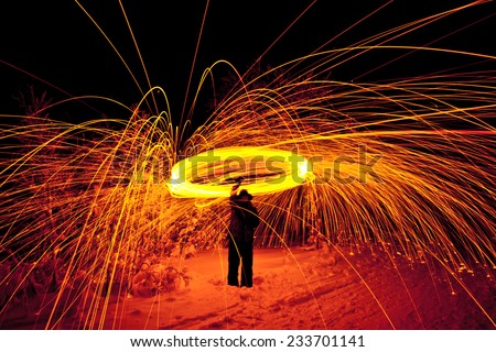 fire painting, light painting with sparks at winter
