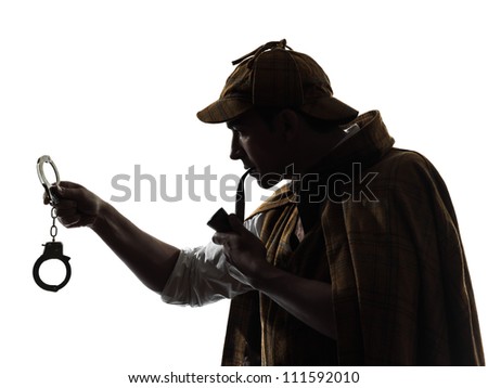 sherlock holmes holding handcuffs silhouette in studio on white background